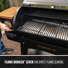 Black Austin XL grill with flame broiler lever for direct flame searing.