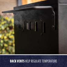 Close-up of a black grill’s back vents releasing smoke, designed to help regulate cooking temperature.