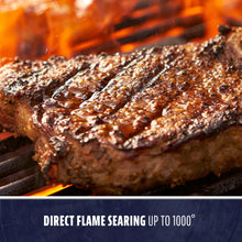 Grilled steak with char marks on a hot grill, direct flame searing up to 1000°.