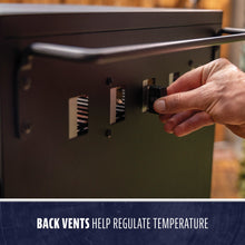 Close-up of a hand adjusting back vents on a black appliance; vents help regulate temperature.