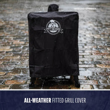 Black all-weather fitted grill cover with Pit Boss logo, shown in rain on wet pavement. Durable and water-resistant.