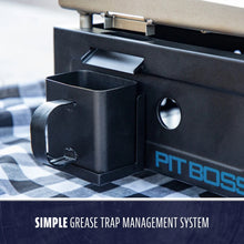 Black metal grease trap cup attached to a grill, labeled "Pit Boss." Simple, easy-to-clean grease management system.