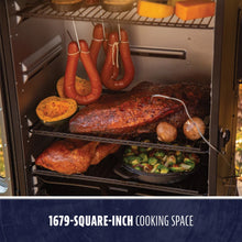 "Black smoker with 1679-square-inch cooking space, holding meats, vegetables, and sausages."