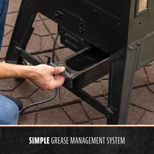 Black outdoor grill with simple grease management system.