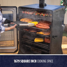 Large black vertical smoker with multiple racks, filled with meats and veggies. Features 1679 sq. in. cooking space.