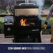 Large black pellet grill and smoker with digital controls, open lid, visible flames, and 2234 sq. in. cooking space.