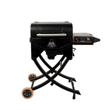 Black portable pellet grill with folding legs, control panel, and orange-accented wheels. Ideal for outdoor grilling.