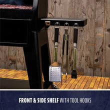 Black grill with front and side shelf, tool hooks, and barbecue tools.