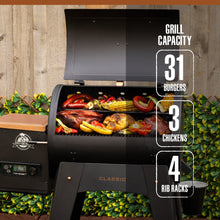 Black Pit Boss Classic grill with 31 burgers, 3 chickens, and 4 rib racks capacity.