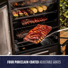 Black grill with four porcelain-coated adjustable grates, cooking ribs and vegetables.