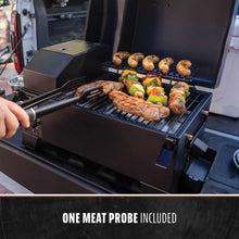 Black electric grill with meat and vegetables cooking, includes one meat probe.
