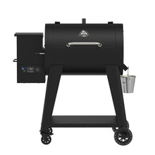 Black Pit Boss pellet grill with digital control panel and water pan.