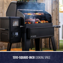 Large black Pit Boss pellet grill with digital controls, open lid, and 1593-square-inch cooking space filled with smoked f...