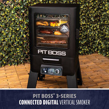 Black vertical digital smoker with glass door, control panel, and visible food racks. "PIT BOSS" logo on front.