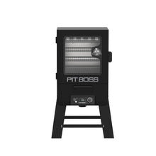 Black Pit Boss smoker with glass door, digital control panel, and multiple cooking racks. Sturdy legs for stability.