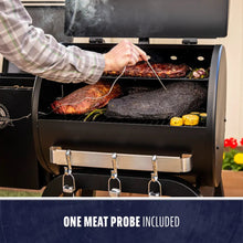 Black smoker grill with meat cooking, one meat probe included.