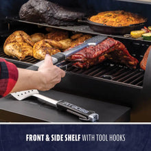 Grill with front and side shelf, tool hooks, and various meats cooking. Easy-access storage for BBQ tools.