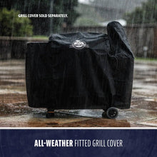 Black Pit Boss all-weather fitted grill cover in rain.