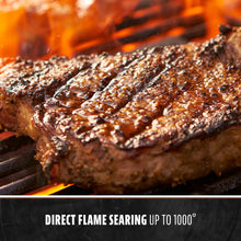 Grilled steak on a flaming grill, direct flame searing up to 1000°.