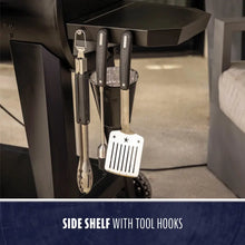"Side shelf with tool hooks holding grill tools."