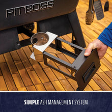 Removable ash tray for Pit Boss grill, shown being pulled out for easy cleaning. Black metal with a silver insert.