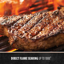 Grilled steak with char marks on a hot grill, showcasing direct flame searing up to 1000°.
