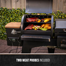 Black Pit Boss Charleston pellet grill with two meat probes included, cooking meats and vegetables.