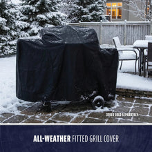 Black all-weather fitted grill cover protects grills from snow and rain; shown outdoors on a snowy patio.