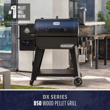 Black Pit Boss DX Series 850 Wood Pellet Grill with digital display and tools.