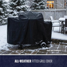 Black all-weather fitted grill cover on snowy patio.